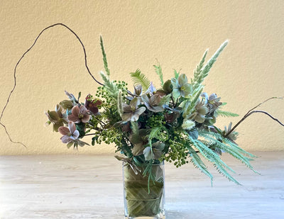 Hellebores roses in leaf-wrap vase