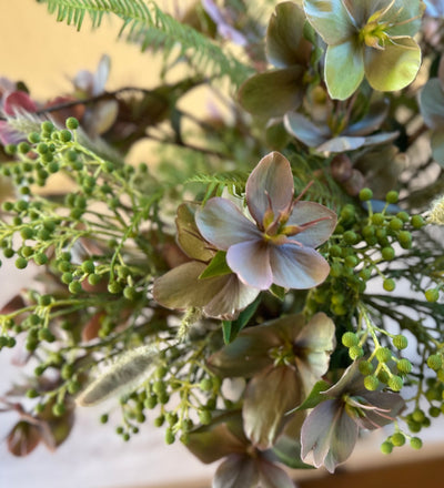 Hellebores roses in leaf-wrap vase