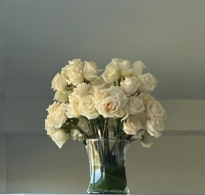 White roses in clear glass