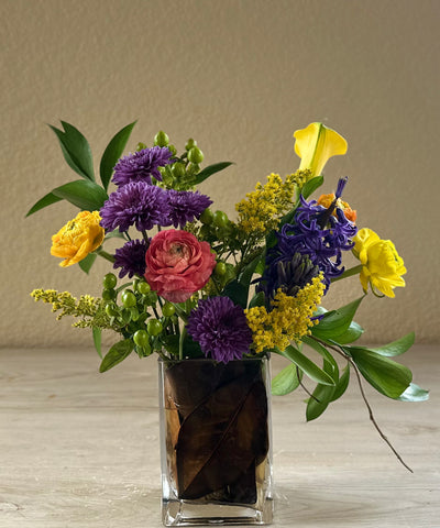 Jewel toned Magnolia Leaf arrangement for same day local delivery