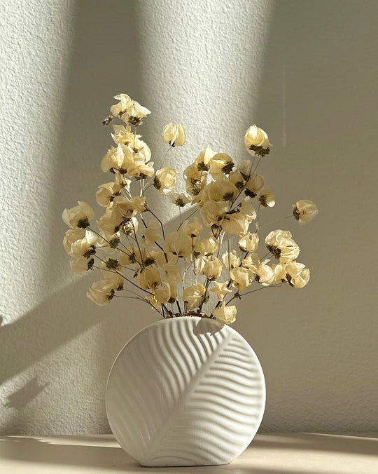 Ivory dried flower arrangement in ceramic vase
