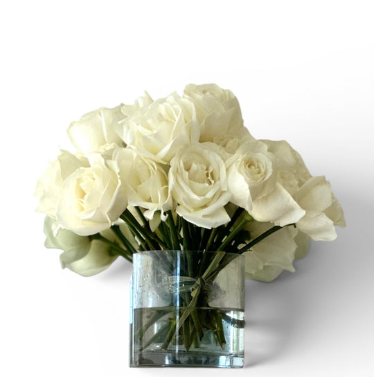 White roses in clear glass